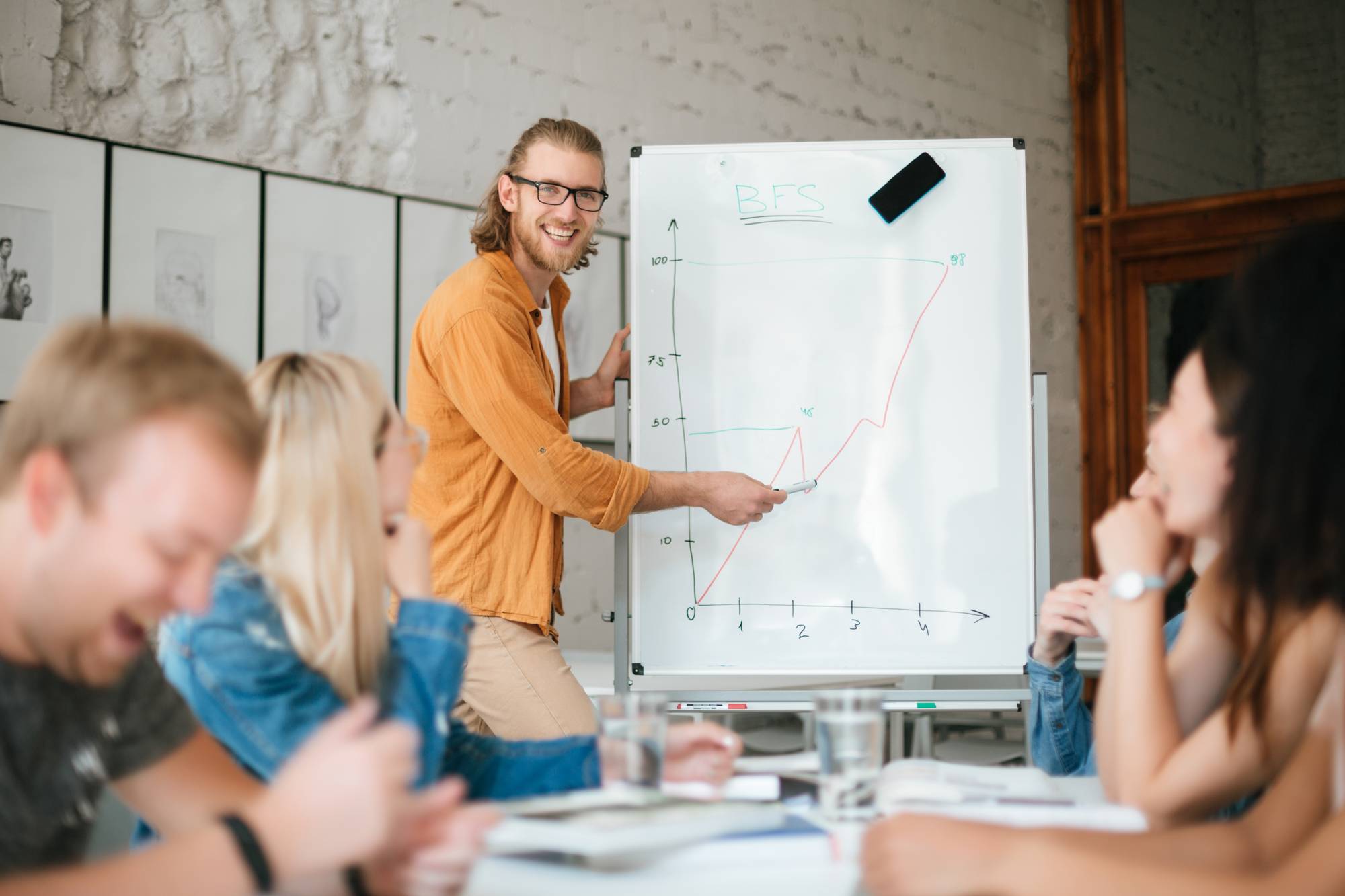 group-of-young-cheerful-students-listening-8W3AJL6